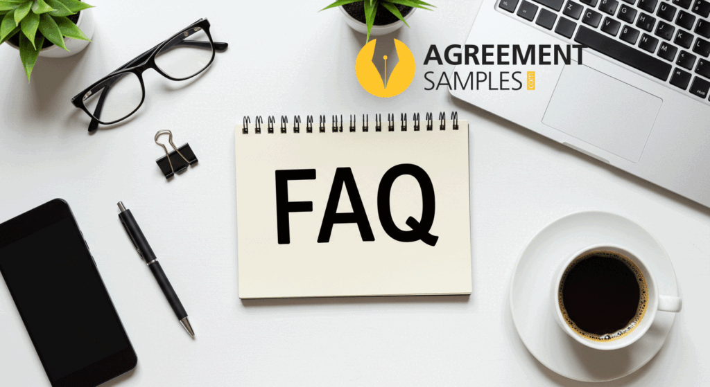 A notebook with FAQ text on it on a desk with laptop, a coffee cup, and a phone.